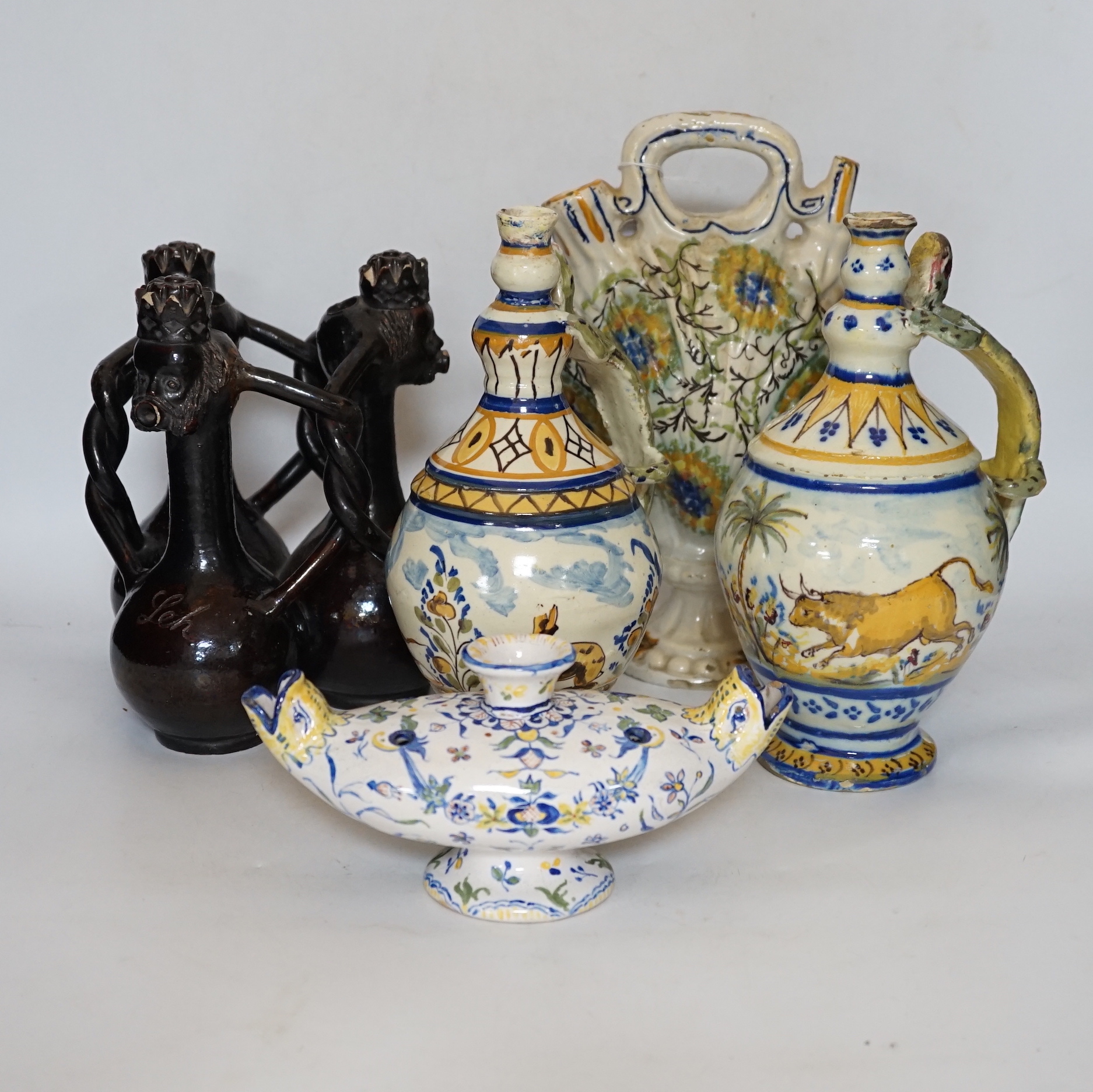 A Slavonic three section brown glazed earthenware puzzle jug and pair of 19th century Portuguese lizard handle maiolica vases and two other similar items, largest 28cm high